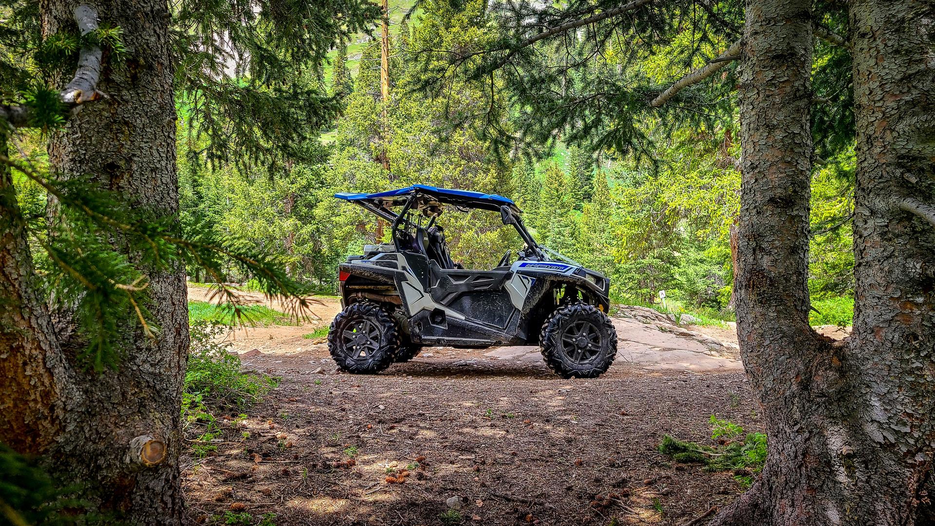 Side by side UTV ATV RZR in the forest along the Yankee Boy Basin trail near Silverton and Ouray Colorado in the San Juan Mountains, Rocky Mountains Colorado.